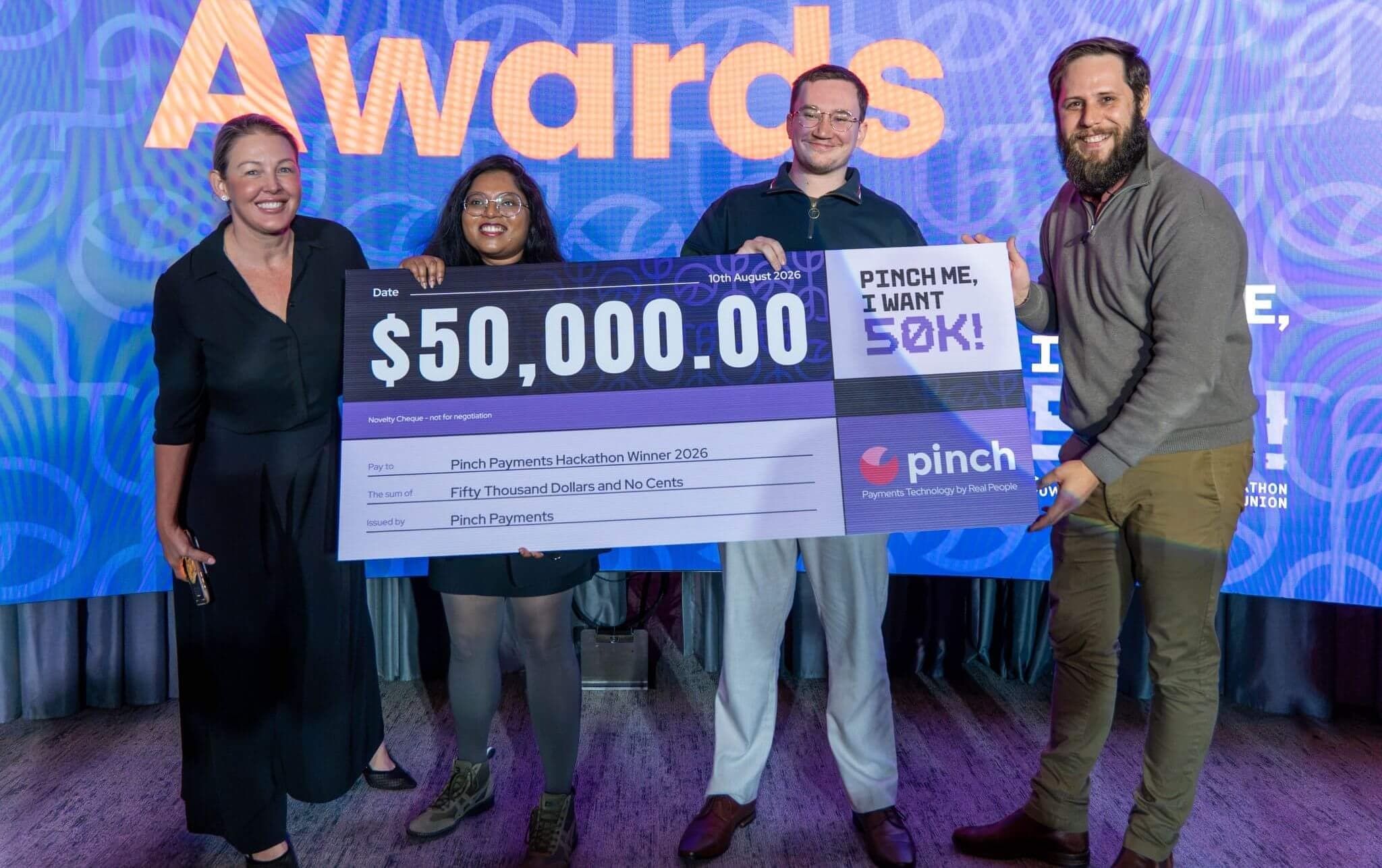 The Volty team accepting the $50,000 Pinch Payments hackathon prize.